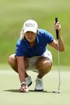 Female Golfer in blue shirt & white dress Sport chic Golf ch